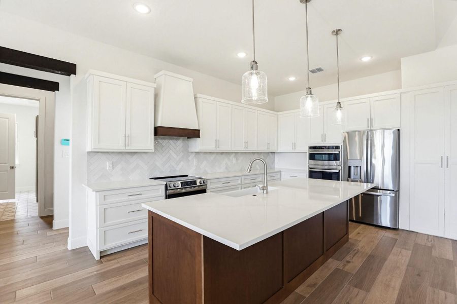 A well-lit culinary space showcases an elegant kitchen island with ample countertop space, perfect for meal preparation.