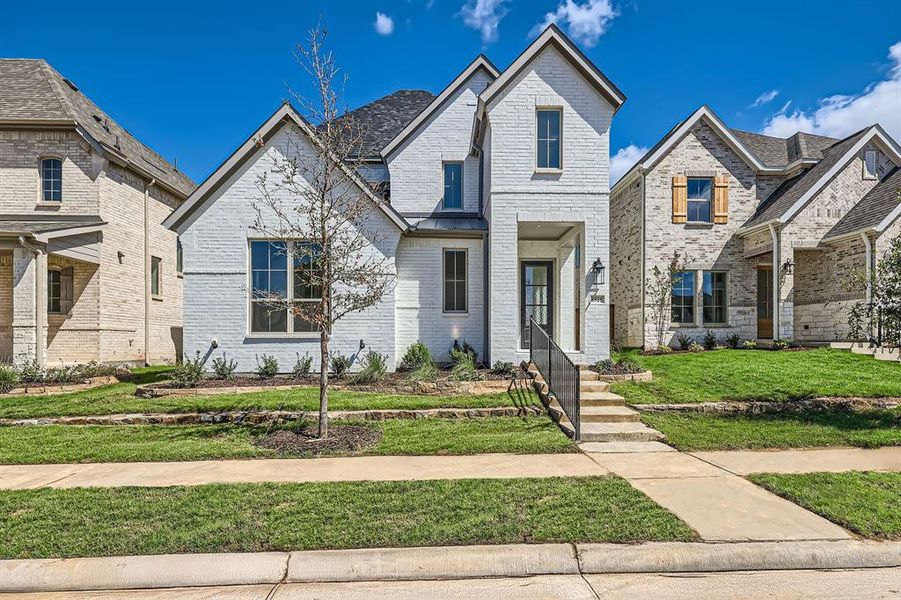 French country home with a front lawn