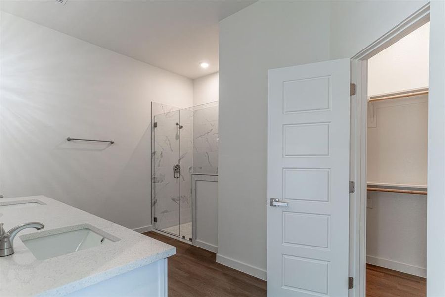 Double vanity, glass shower and walk in closet