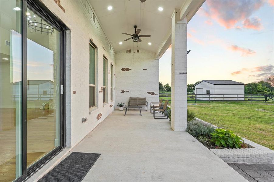 Patio terrace at dusk featuring a ceiling fan Patio terrace at dusk featuring a ceiling fan