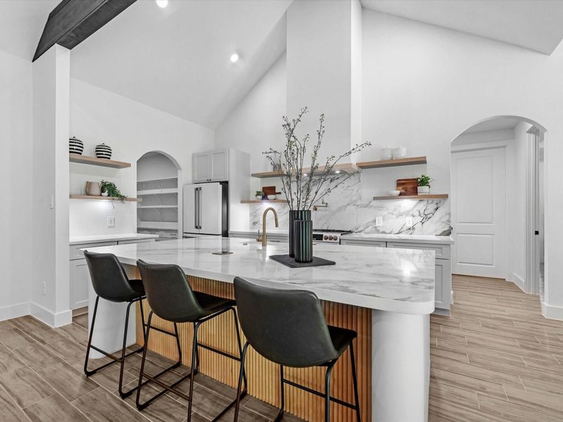 Your spacious kitchen looks amazing! Featuring luxury cafe appliances, gold hardware and a pot filler this is truly a dream.