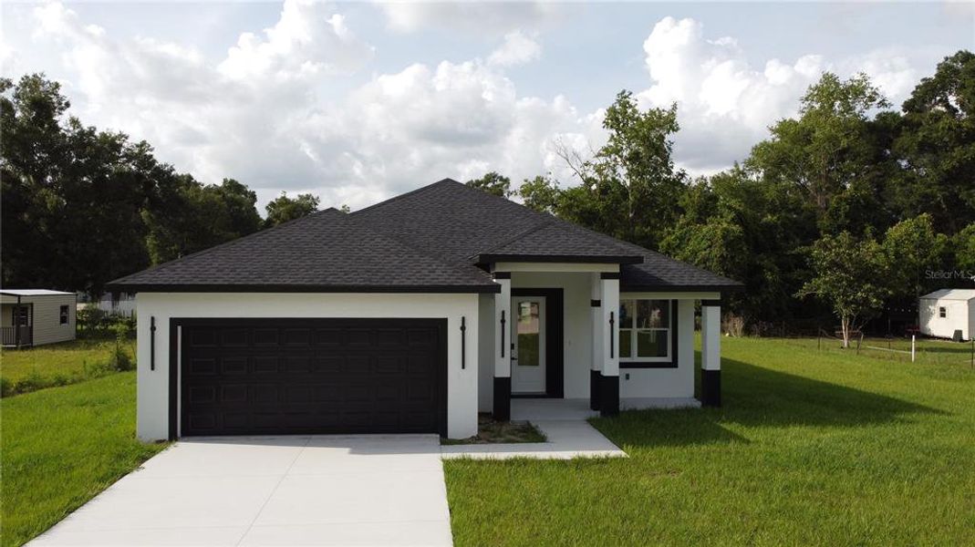Front exterior of a new home in , Summerfield, FL, highlighting curb appeal (Image 23).