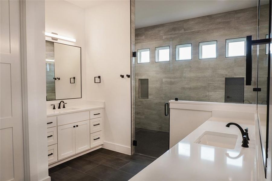 Bathroom featuring walk in shower and vanity