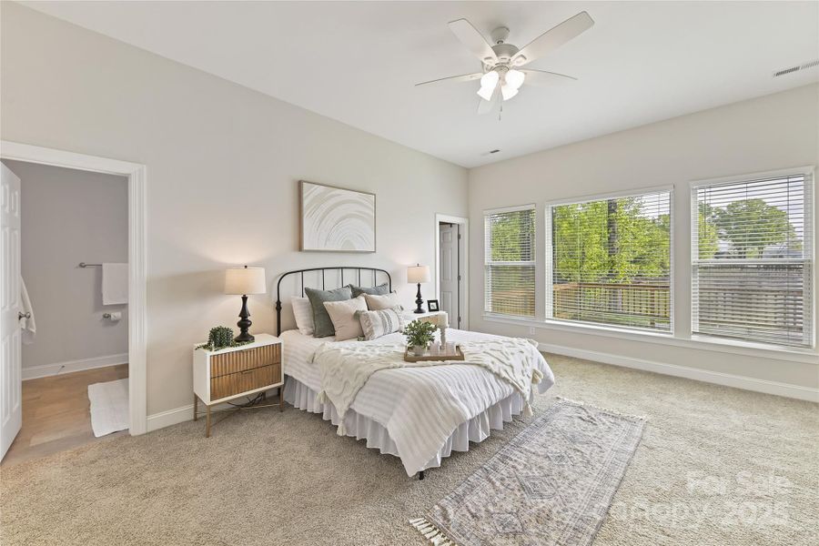 Primary Suite with ceiling fan/light, private bath, walk in closet & large windows for prefect lake views!