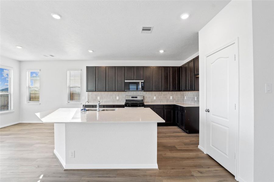 Designed for entertaining, this impressive central island offers seating for guests and a generous prep space, making it a natural hub for parties and family get-togethers Designed for entertaining, this impressive central island offers seating for guests and a generous prep space, making it a natural hub for parties and family get-togethers