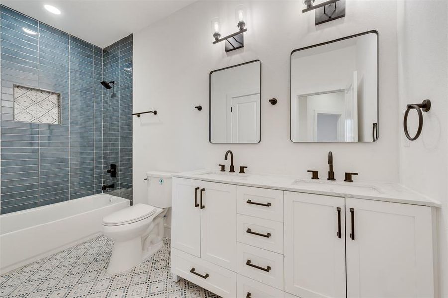 Full bathroom featuring vanity, toilet, and tiled shower / bath