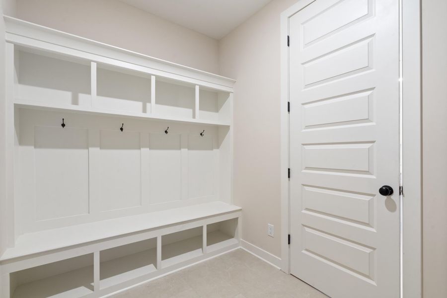 Built-in mudroom bench with cubbies, overhead shelving, and coat hooks Built-in mudroom bench with cubbies, overhead shelving, and coat hooks