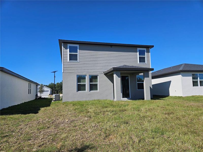 Exterior details and patio area of a home in The Reserve at Hammock Oaks - Classic Series, Lady Lake (Image 3).