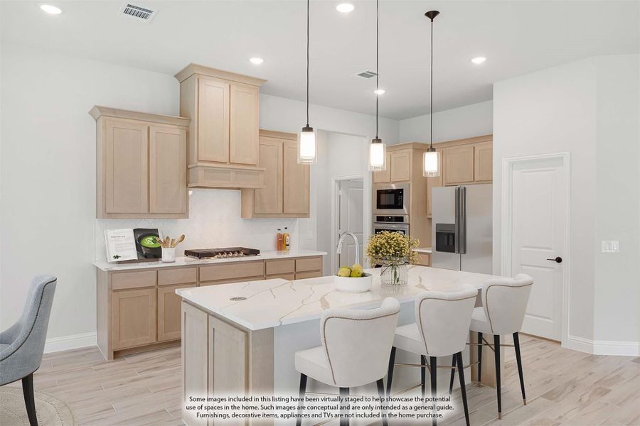 Kitchen with light wood cabinets, white quartz island, pendant lights, and stainless steel appliances Kitchen with light wood cabinets, white quartz island, pendant lights, and stainless steel appliances
