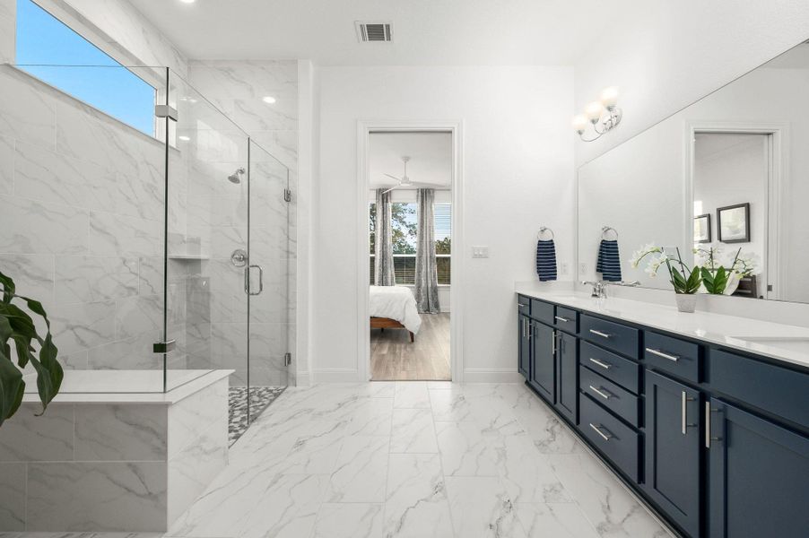 The primary bathroom offers a calming, spa-inspired design complete with a large walk-in shower and an impressive closet The primary bathroom offers a calming, spa-inspired design complete with a large walk-in shower and an impressive closet