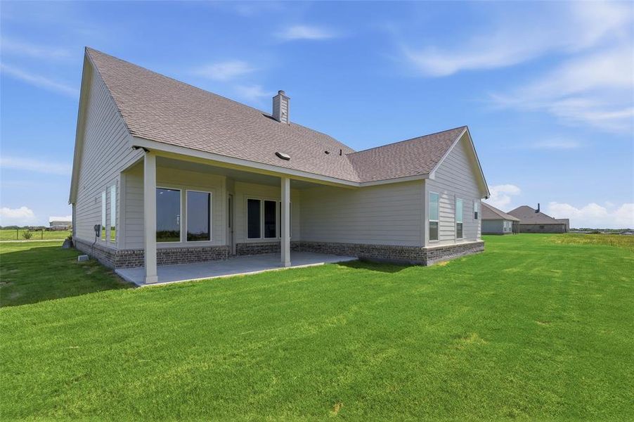 Spacious covered patio with concrete flooring Spacious covered patio with concrete flooring