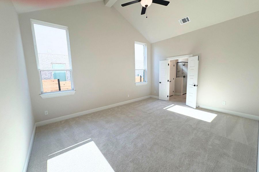 High vaulted ceilings and soft carpet floorings define this airy main bedroom retreat. High vaulted ceilings and soft carpet floorings define this airy main bedroom retreat.