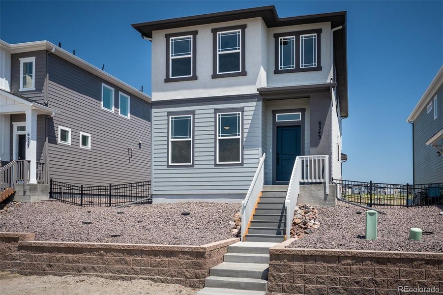 Front exterior of a new home in Revel Crossing at Wolf Ranch – The Ascent Collection, Colorado Springs, CO, highlighting curb appeal (Image 2).