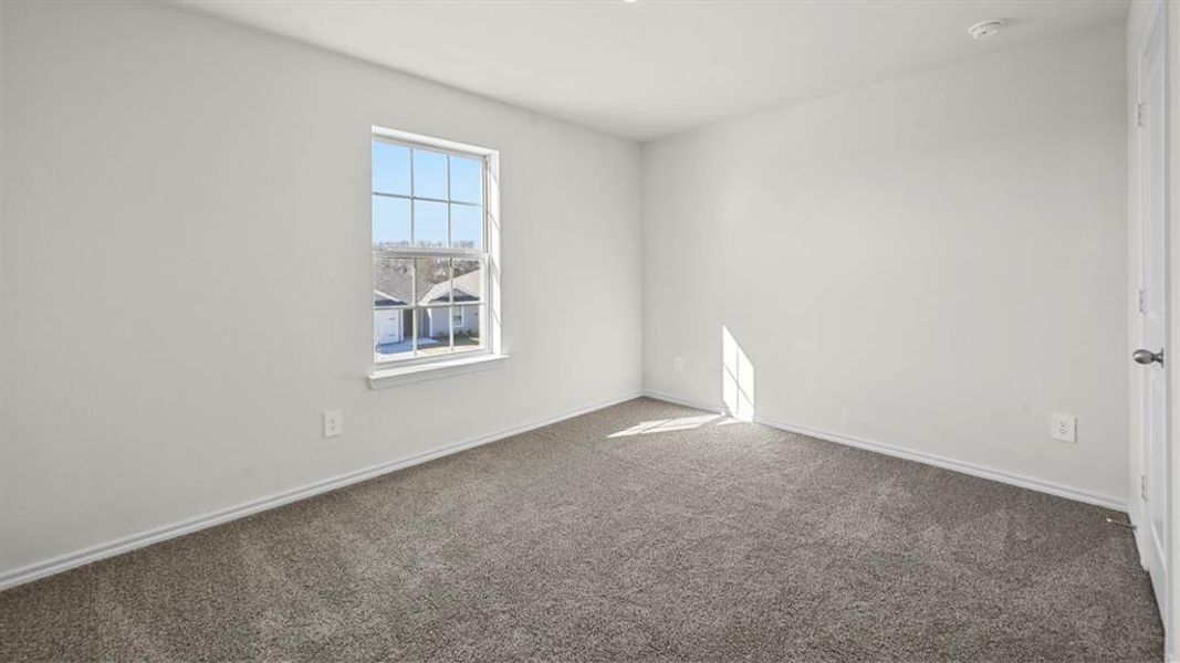Room featuring neutral-toned walls, gray carpeting, and white baseboards
