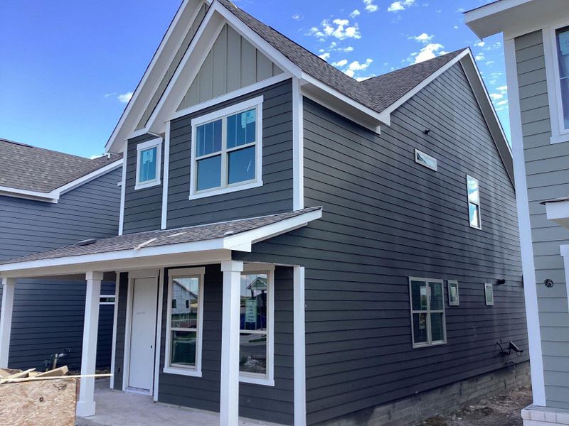 Front exterior of a new home in The Cottages at Lariat, Liberty Hill, TX, highlighting curb appeal (Image 22).