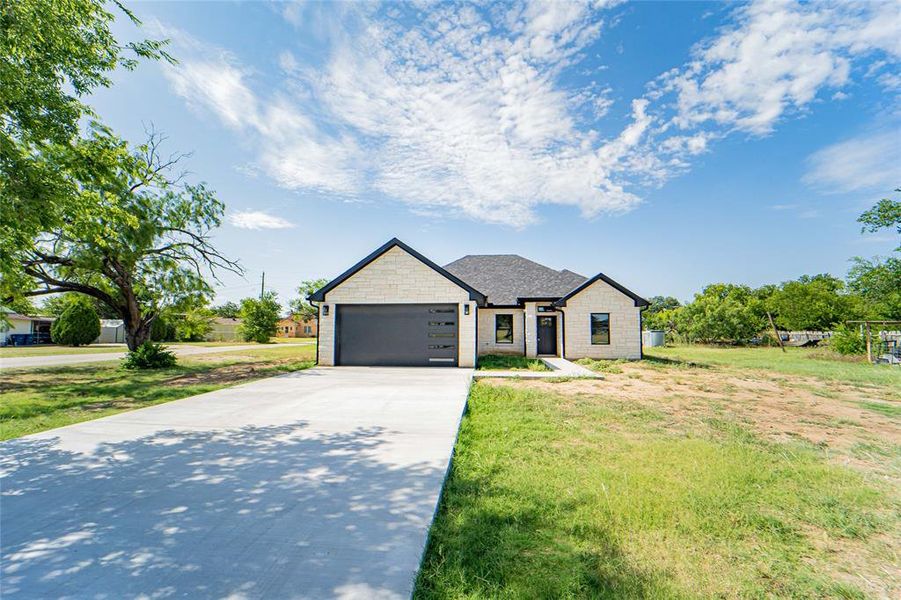 Contemporary single-story residence featuring a stone-look facade