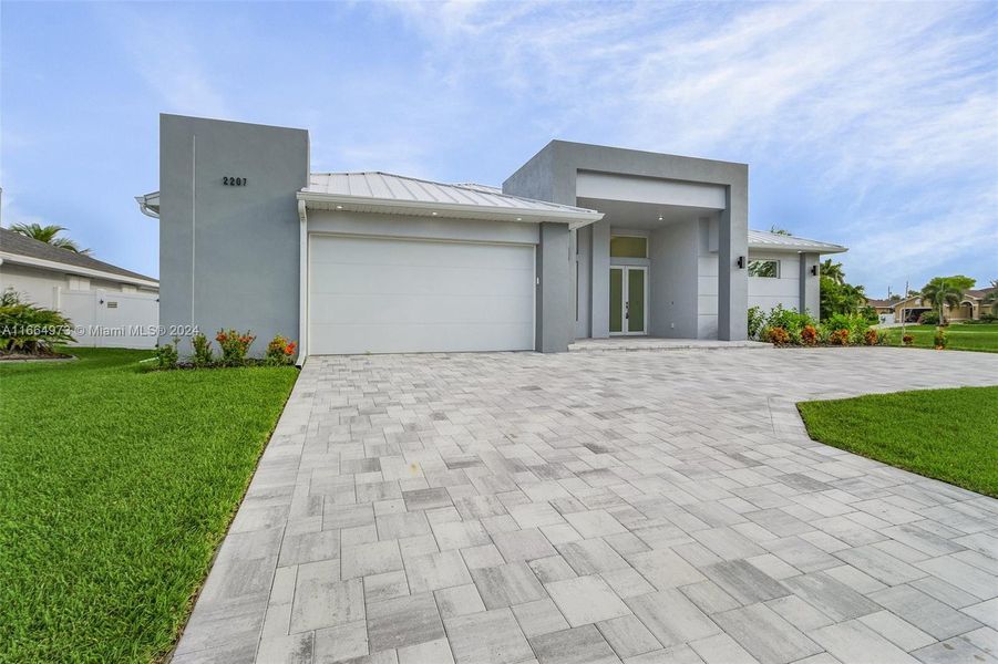Front exterior of a new home in , Cape Coral, FL, highlighting curb appeal (Image 1).
