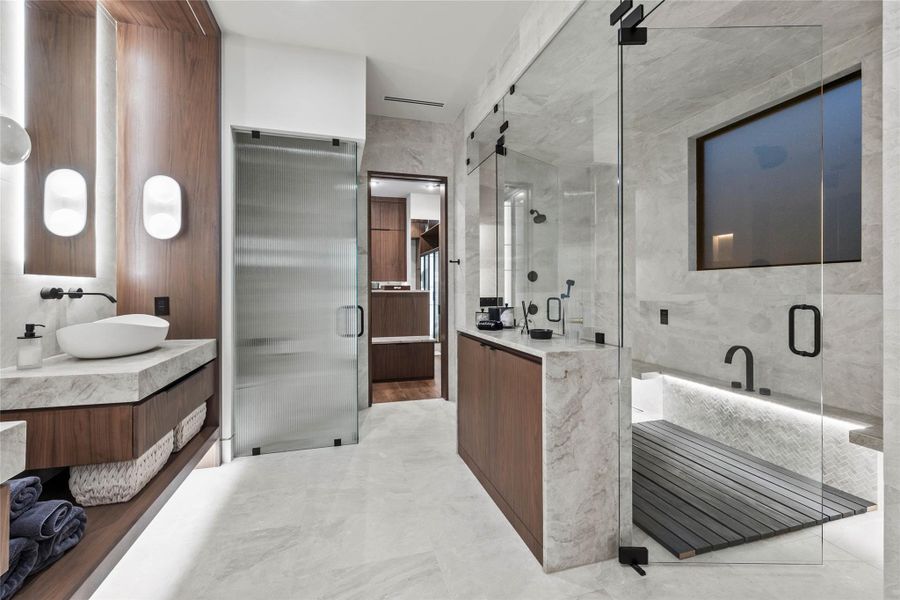 Spacious bathroom featuring a large walk-in shower with glass enclosure, wood-finish slat flooring, and integrated lighting