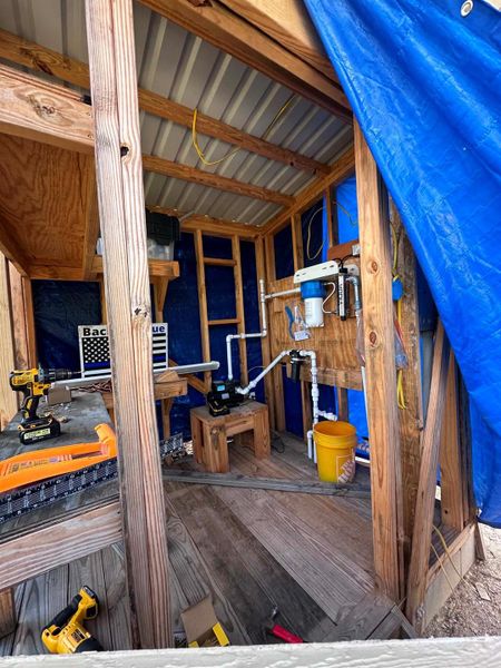 Essential utilities are housed in a well-organized shed, offering practicality and convenience.