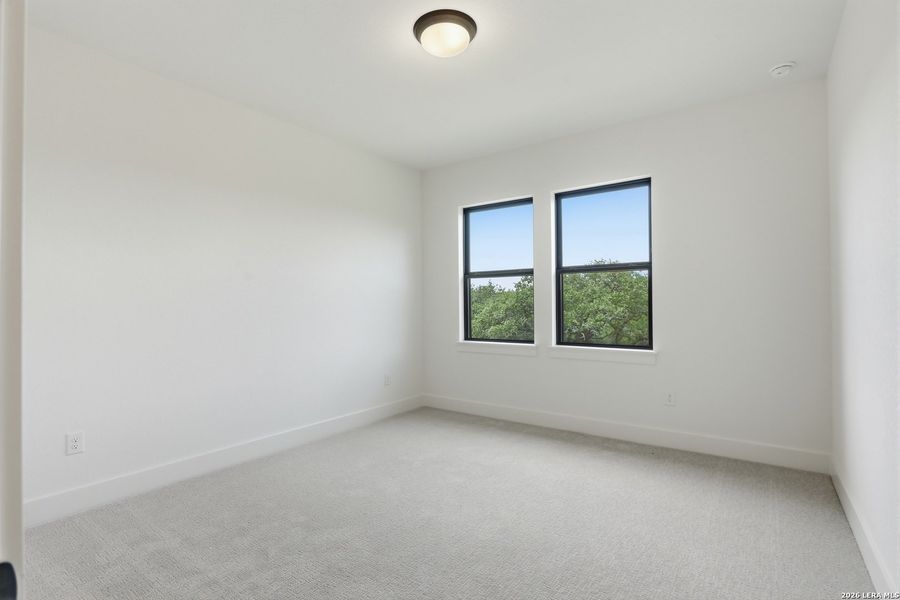 Spacious, unfurnished interior of a new home in Enchanted Bluff, San Antonio (Image 40).
