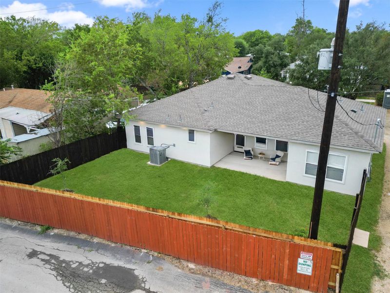 Back of property with stucco siding, roof with shingles, a patio area, and a fenced backyard Back of property with stucco siding, roof with shingles, a patio area, and a fenced backyard