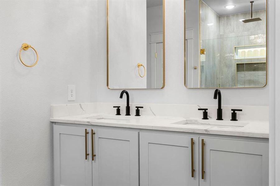 Bathroom featuring a tile shower and vanity