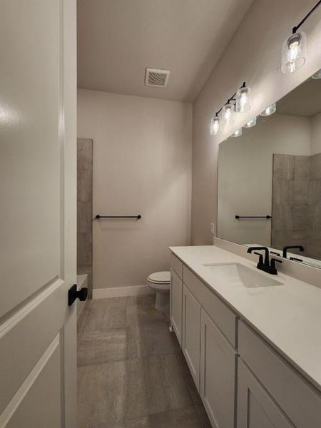 Bathroom featuring vanity and a shower