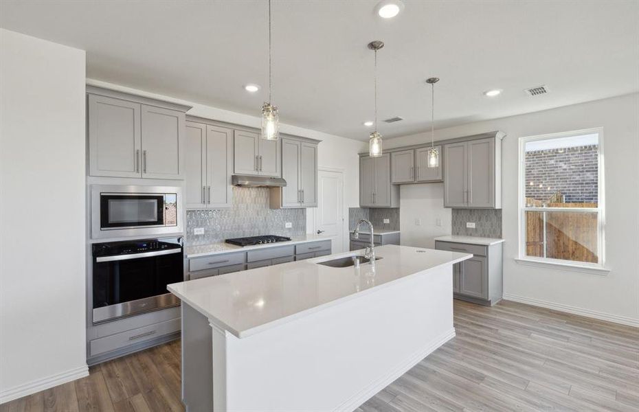 Bright kitchen with oversized island *real home pictured