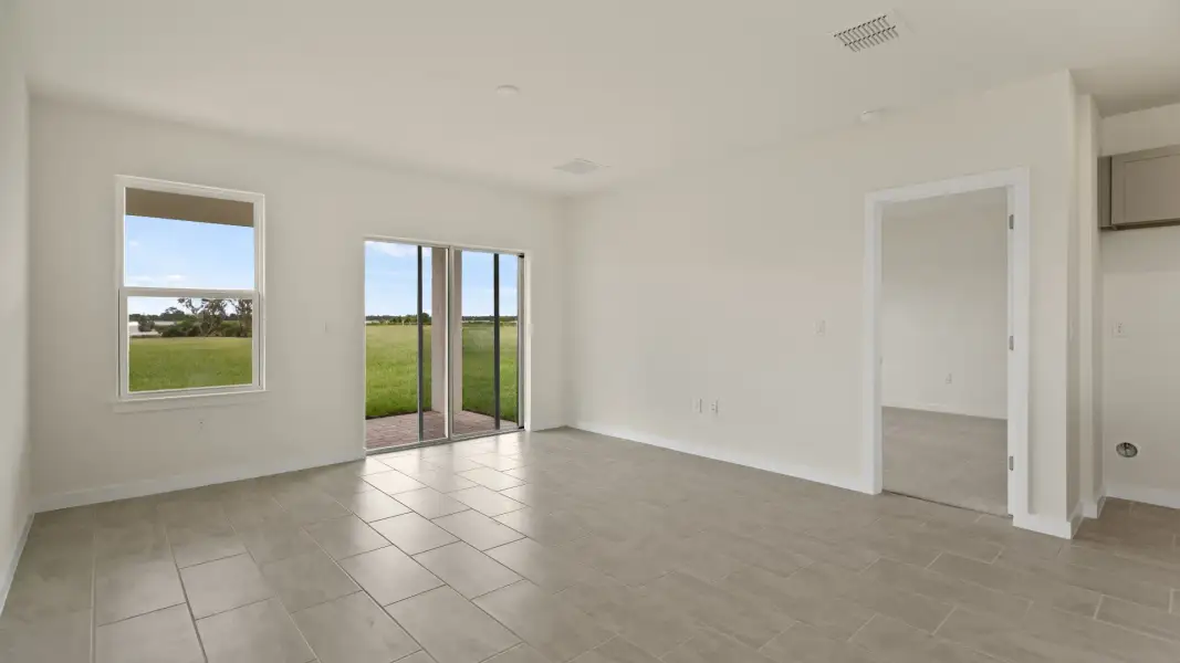 The Naples Kitchen with large Island Quick Move-In Home at Willowbrook North by DRB Homes in Winter Haven, FL