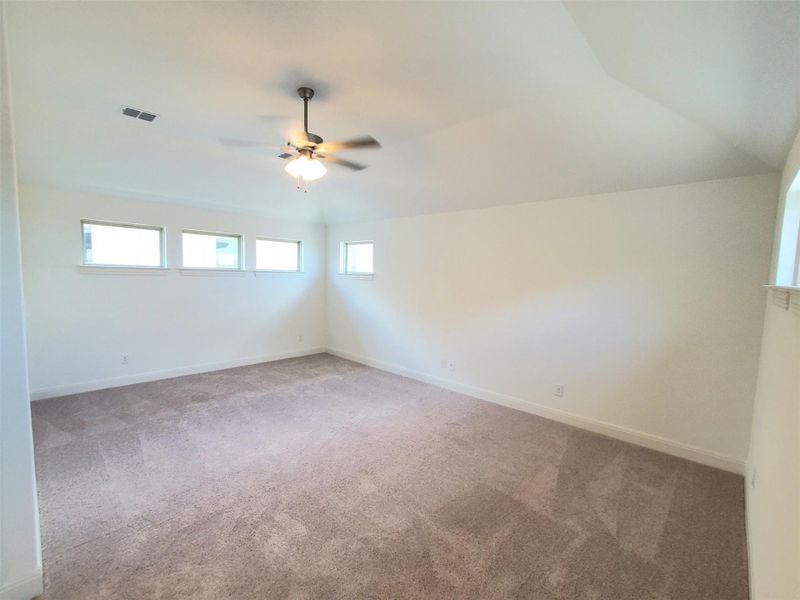 Unfurnished room featuring ceiling fan, light carpet, and baseboards Unfurnished room featuring ceiling fan, light carpet, and baseboards