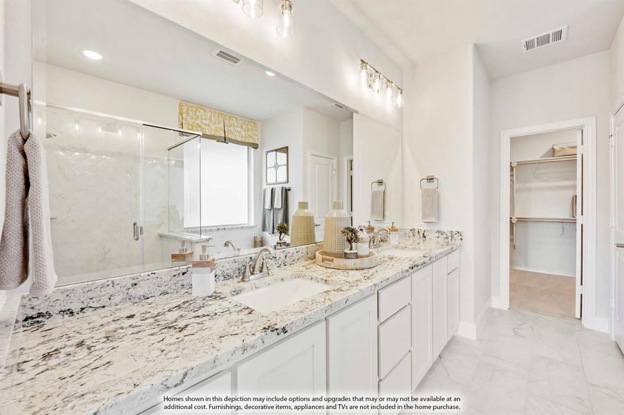 Master bathroom with double vanity, granite countertops, glass shower, and walk-in closet entrance. Master bathroom with double vanity, granite countertops, glass shower, and walk-in closet entrance.