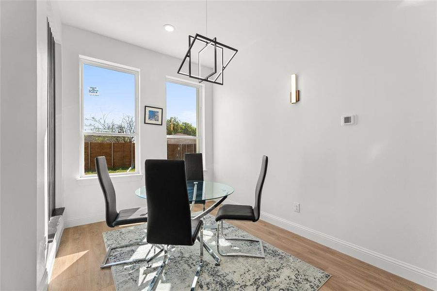 Dining area with a chandelier and light wood-style flooring