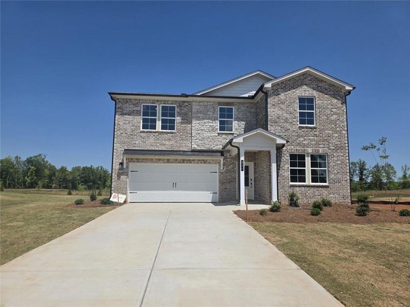 Front exterior of a new home in Walker Grove, McDonough, GA, highlighting curb appeal (Image 19). Front exterior of a new home in Walker Grove, McDonough, GA, highlighting curb appeal (Image 19).