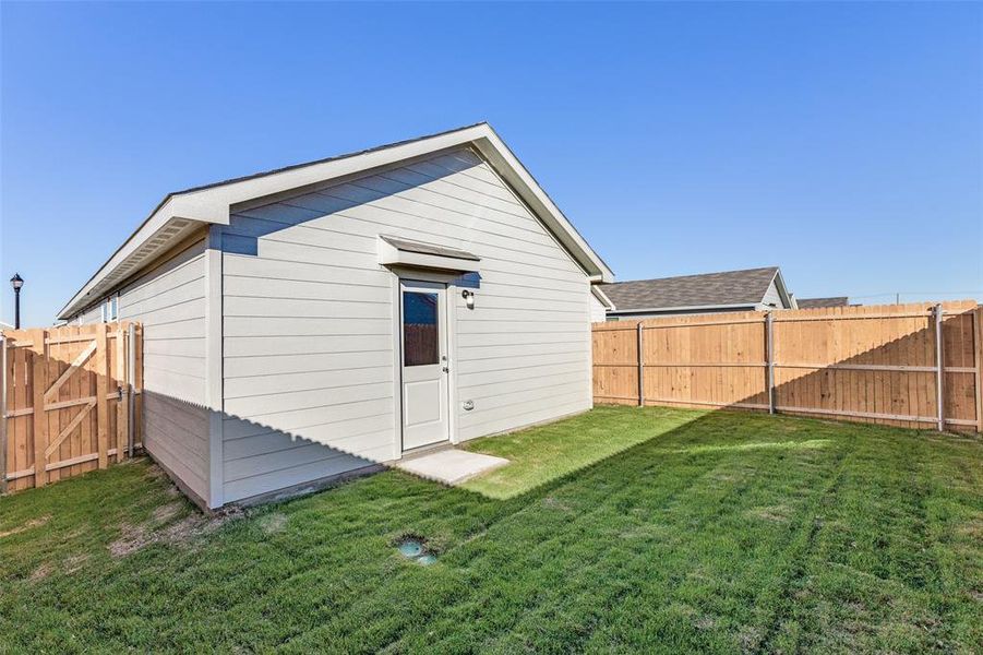 Back of house featuring a lawn