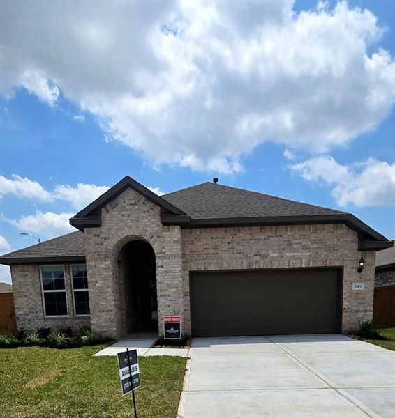 Front exterior of a new home in Sunterra, Katy, TX, highlighting curb appeal (Image 15).