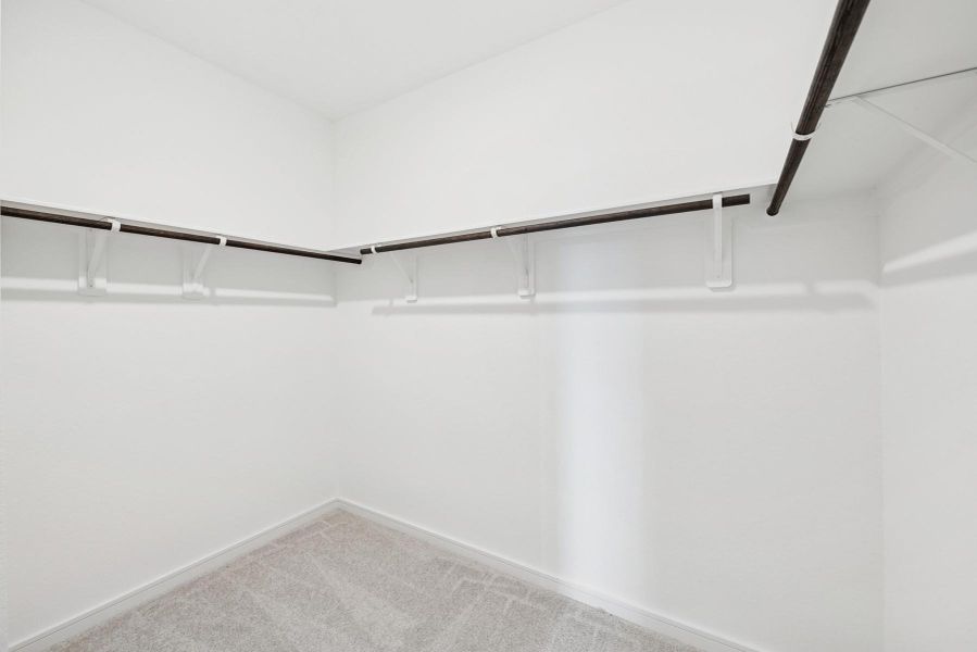 Walk-in closet in the primary suite (*Photo not of actual home and used for illustration purposes only.)