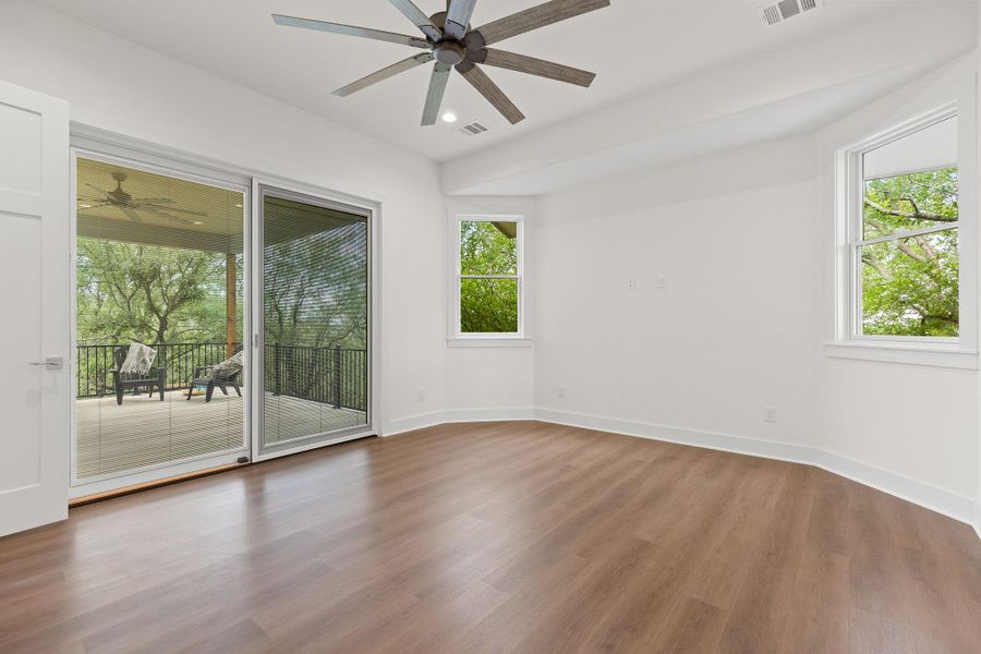 Unfurnished room with a ceiling fan, wood finished floors, and baseboards Unfurnished room with a ceiling fan, wood finished floors, and baseboards