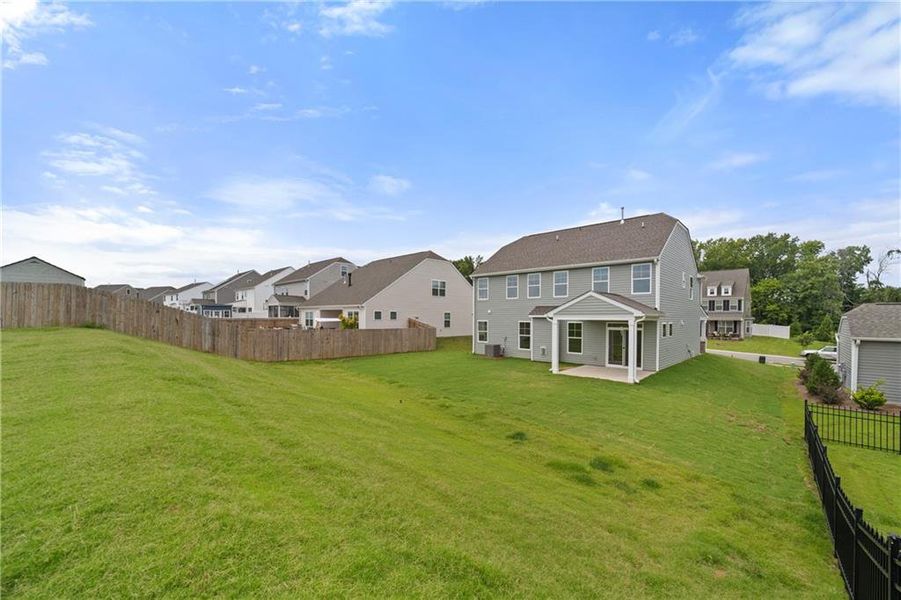Exterior details and patio area of a home in Twin Lakes, Hoschton (Image 16).
