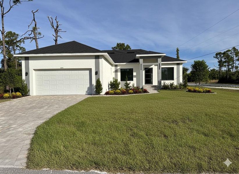 Front exterior of a new home in , Port Charlotte, FL, highlighting curb appeal (Image 1).