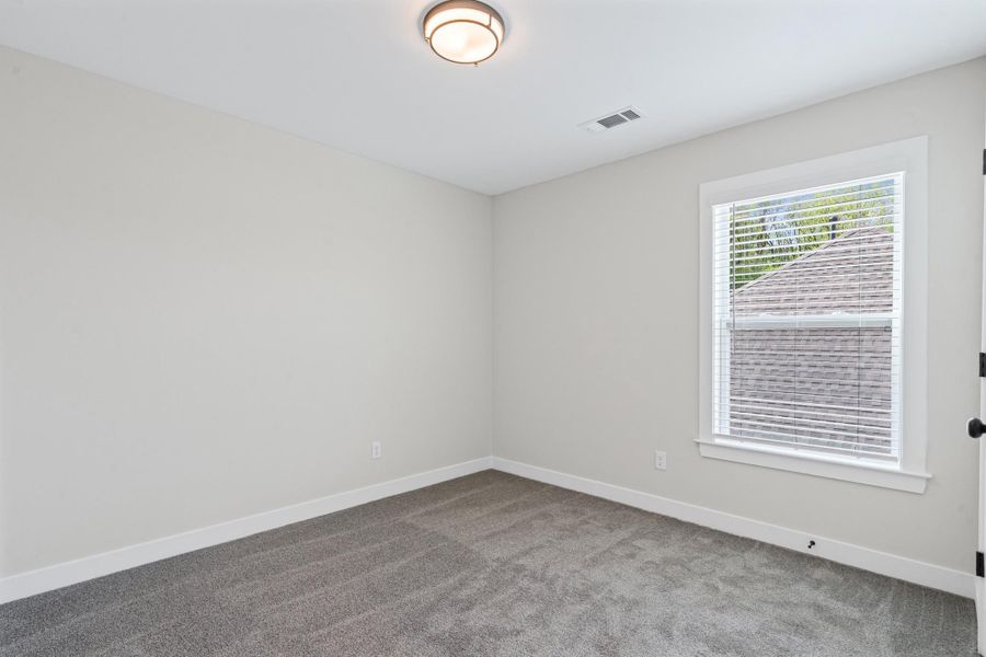 Carpeted spare room featuring baseboards Carpeted spare room featuring baseboards