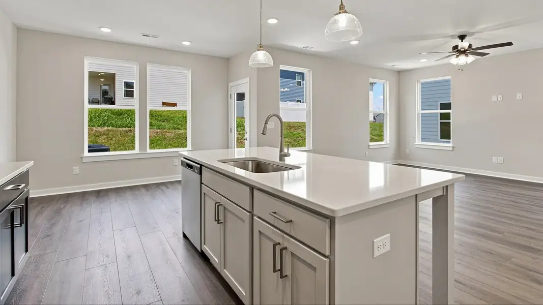 View of community and of kitchen island paired with essential sink and dishwasher