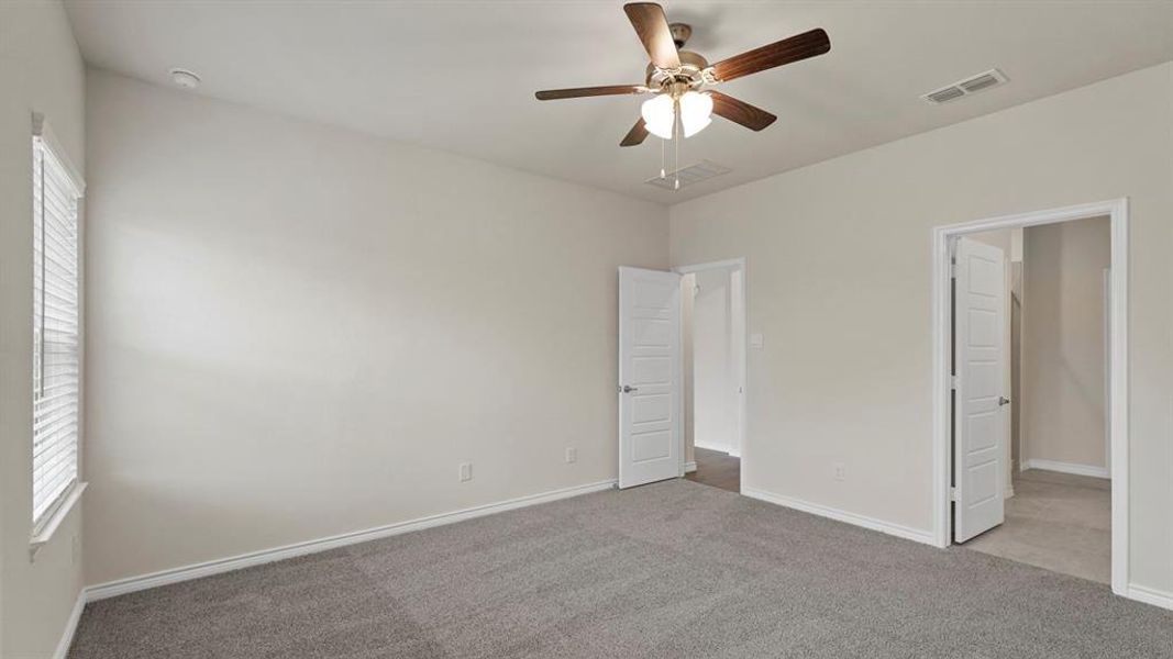 Unfurnished bedroom featuring carpet flooring and ceiling fan Unfurnished bedroom featuring carpet flooring and ceiling fan