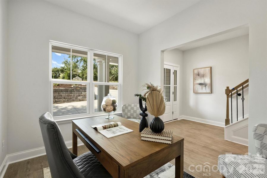 Flexible front room offering versatility as a home office, dining area, or additional living space.