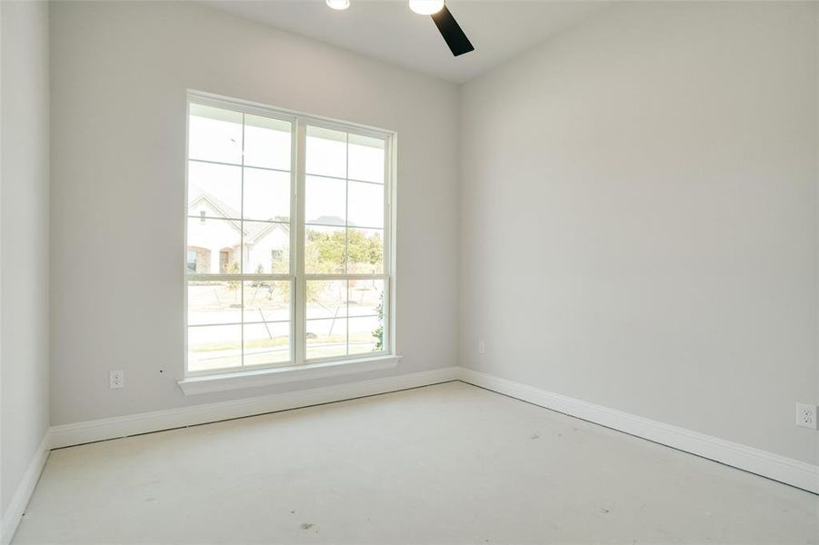 Spare room with ceiling fan