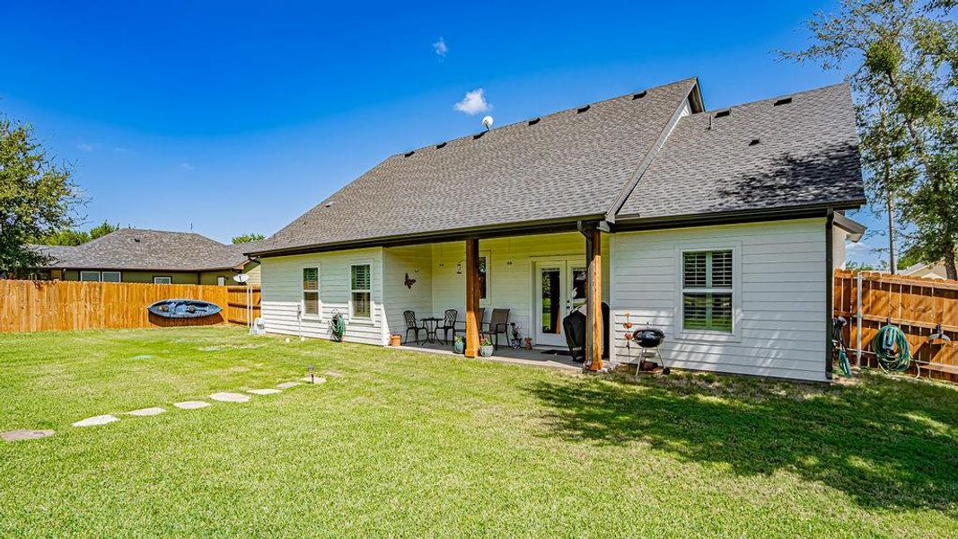 Back of property with a patio and a yard