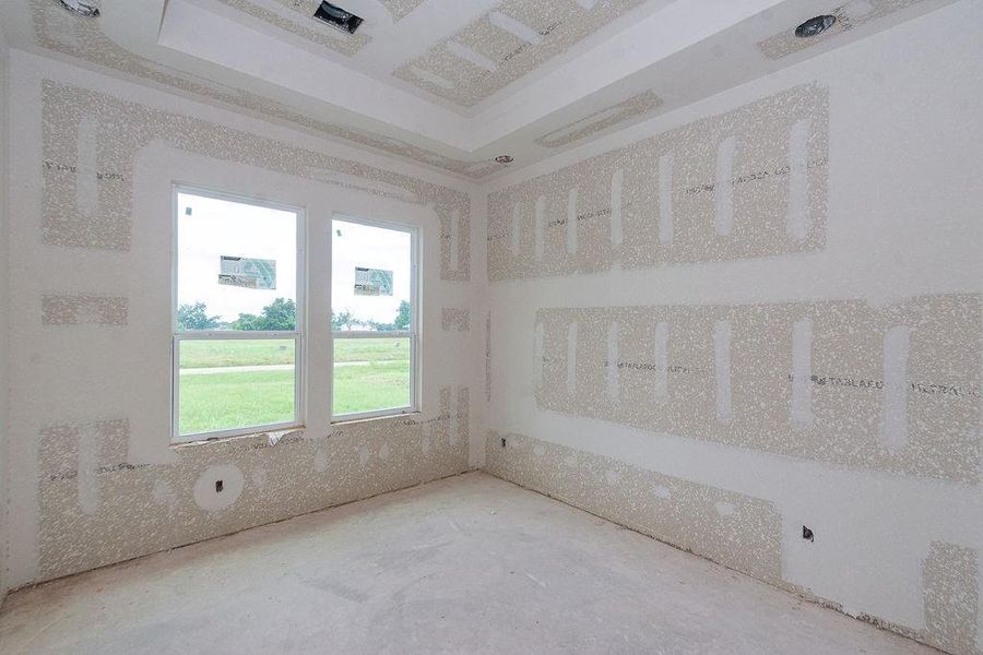 Bright room under construction with large windows offering a view of lush greenery, ready for your personal touches. Bright room under construction with large windows offering a view of lush greenery, ready for your personal touches.