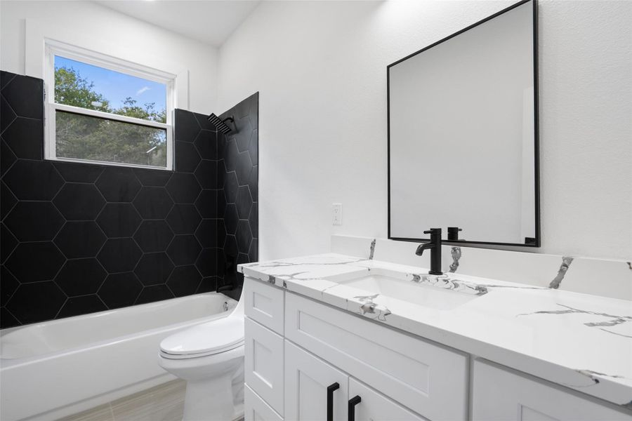 Bathroom featuring shower / bathtub combination and vanity Bathroom featuring shower / bathtub combination and vanity
