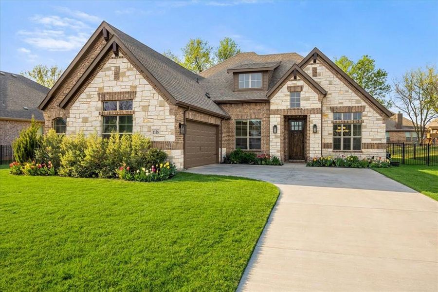 Front exterior of a new home in Abe's Landing, Granbury, TX, highlighting curb appeal (Image 1). Front exterior of a new home in Abe's Landing, Granbury, TX, highlighting curb appeal (Image 1).