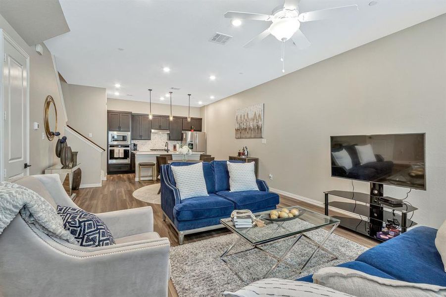 Living room featuring ceiling fan and wood-type flooring