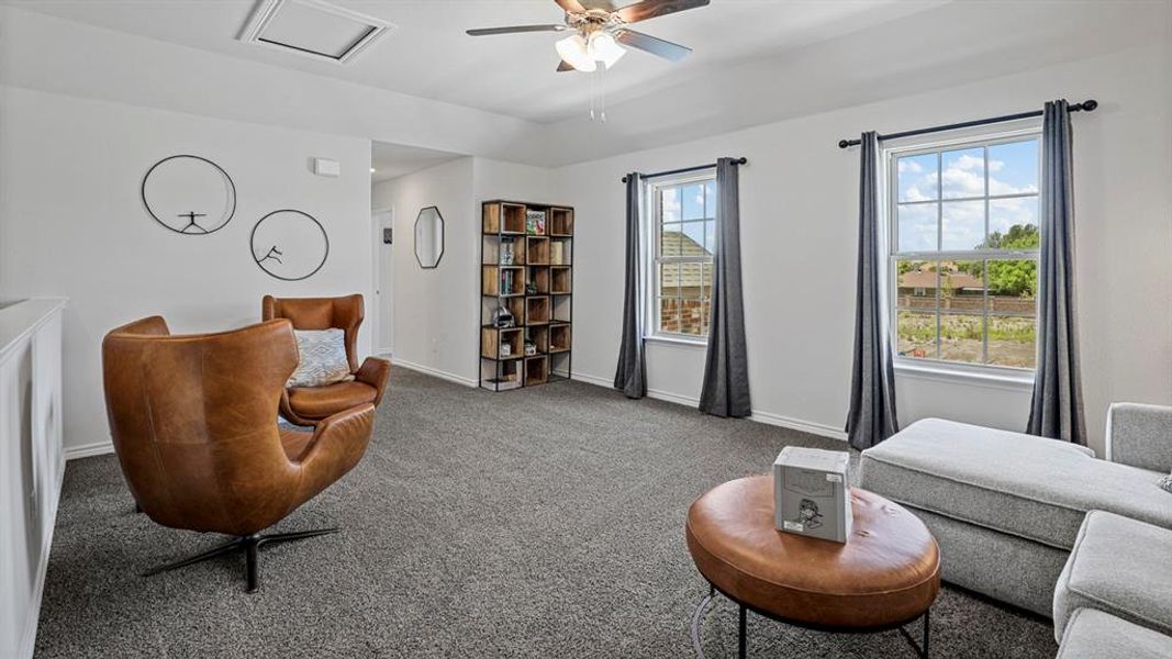 Living area with carpet flooring and ceiling fan